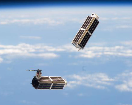 A set of NanoRacks CubeSats is photographed by an Expedition 38 crew member after the deployment by the Small Satellite Orbital Deployer (SSOD).