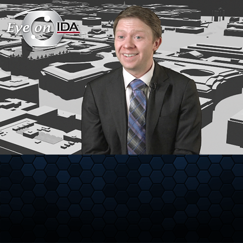 Video frame showing Tyler Morgan-Wall with cityscape visualization backdrop